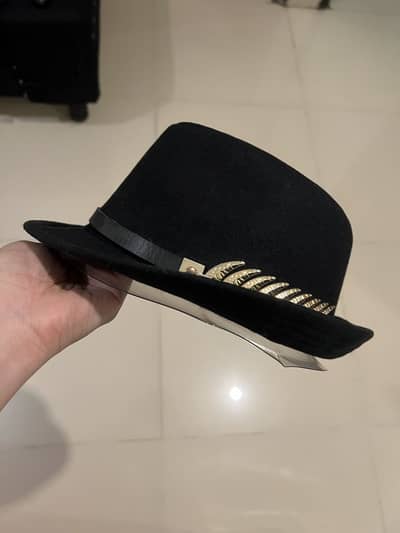 Brand new hat with metal feather