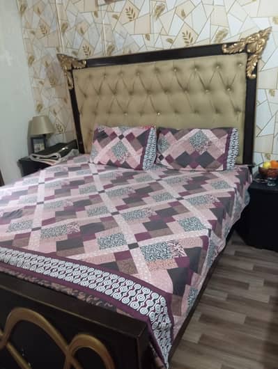 bed along with 2 side tables and dressing