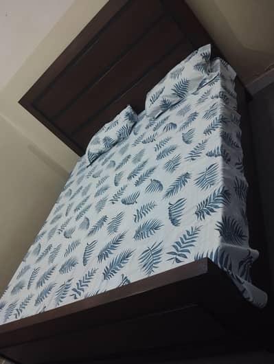 wooden bed with mattress