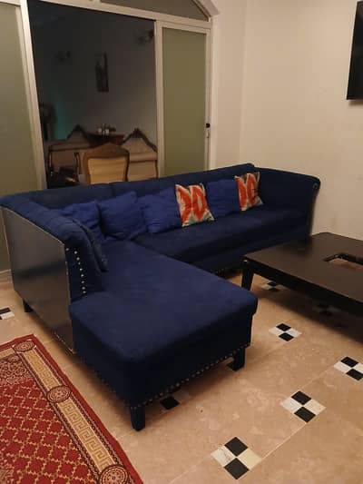 L shape sofa with two plushie and table