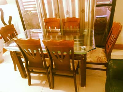 Decent dining table with six chairs.