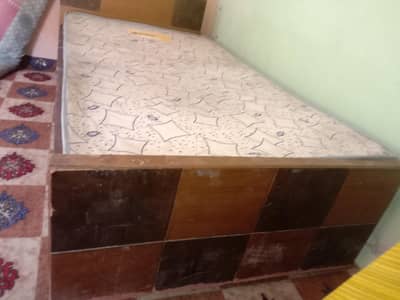 single wooden bed with metress