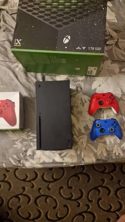 Xbox series x and two controllers