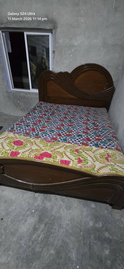 wooden bed with mattress