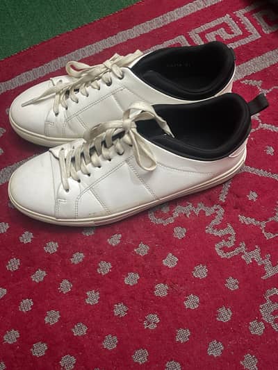 white sneakers plus black Oxford shoes
