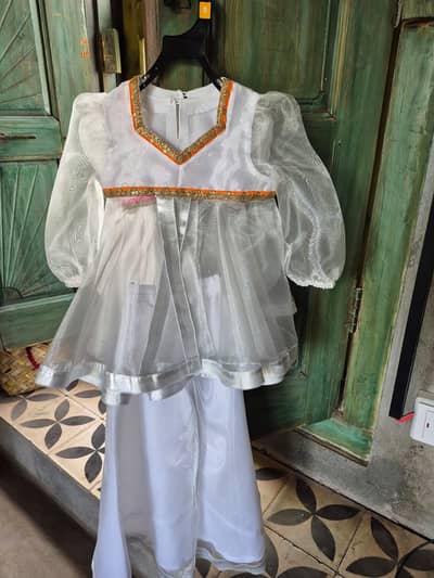 Baby girls pishwas eid clothing in flourescent pink and orange laces.