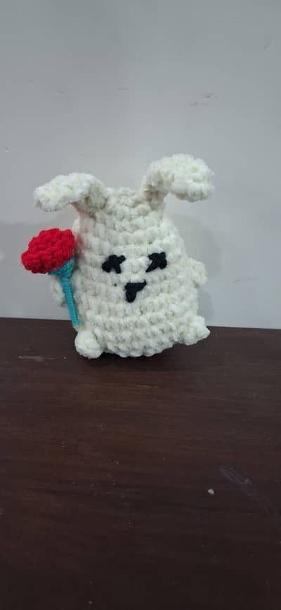 handmade crochet stuffed bunny with a rose.