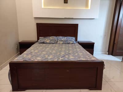 Double bed with mattress and side table