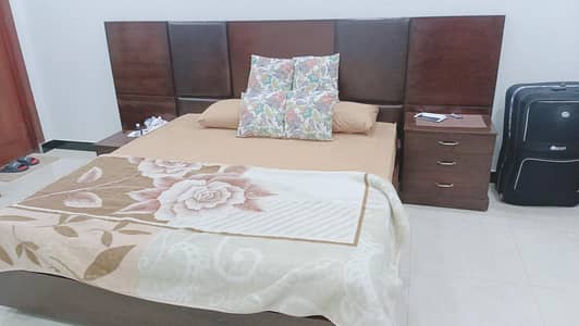 king size bed with side tables and a dressing table