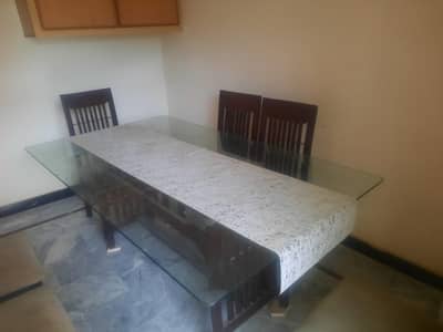 6 chairs wooden dining table with glass top.