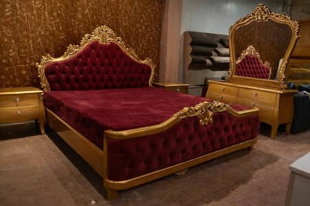 wooden bed with two side tables and dressing table