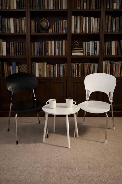 Two weather proof black & white Chairs.