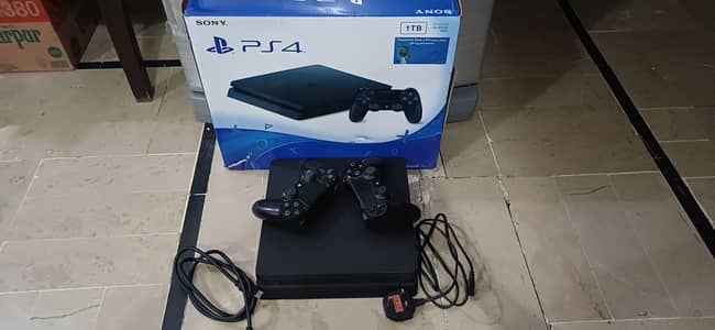 PS4 SLIM 1TB WITH BOX AND 2 CONTROLLERS