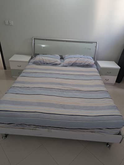 Bed with mattress and side tables