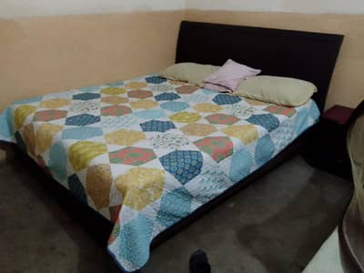 double bed with 02 small tables. . . .