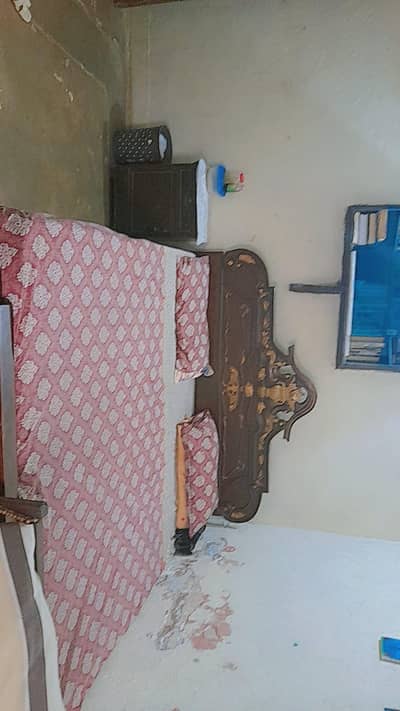 Wooden bed with mattress and side table