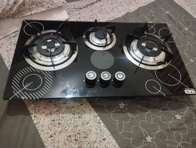 Elegant 3-burner gas stove with tempered glass top.