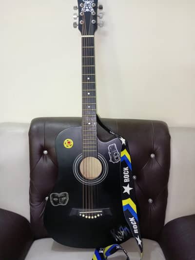 brand new acoustic guitar with a brand new capo and 3 picks
