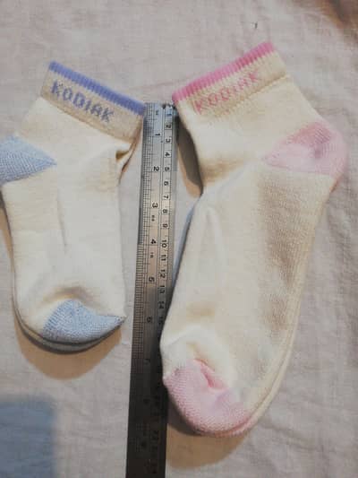 white socks with pink blue hues at heel and toes