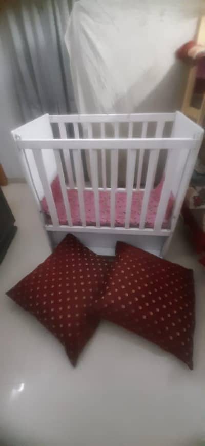 white wooden baby cot