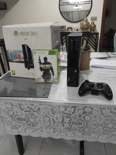 Xbox 360 e with box and games