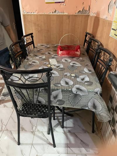 Dining table glass with Six ironn rod charis black & gold colour