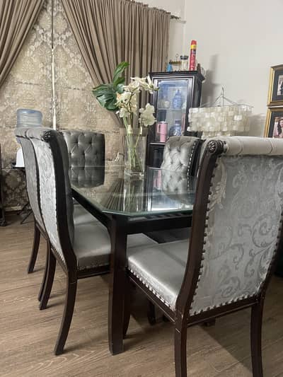 Wooden modern dinning table with six chairs .