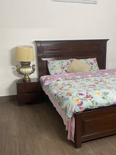 Wooden bed with side tables and dresser with stool