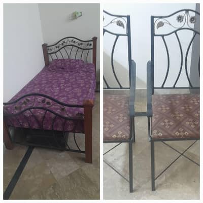 iron bed without mattress and two chairs