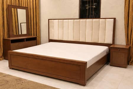 slightly used wooden bed with one side table dressing table