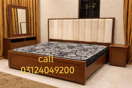 slightly used bed with one side table and dressing table