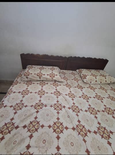 2 single wooden beds without mattress