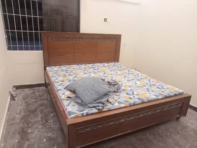 Wooden bed with one side table