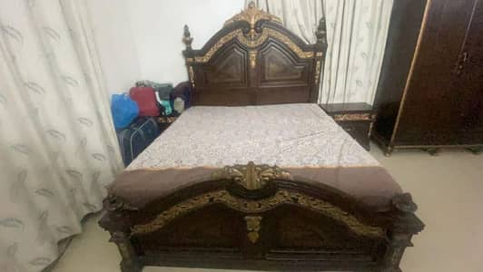 king bed with 2 side tables, dressing table and 3 door cupboard.
