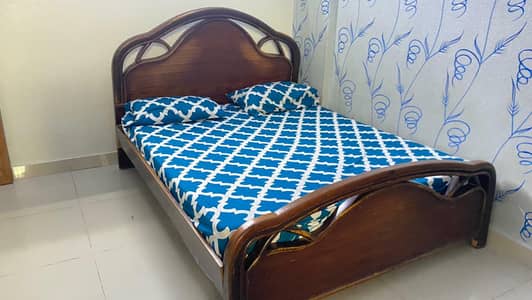 wooden bed with mattress