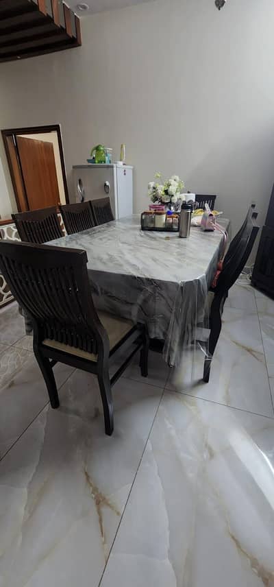 Dining table with eight chairs for urgent sale.