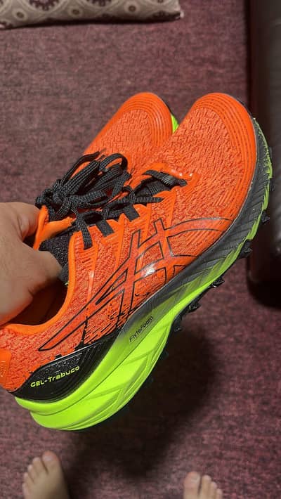 Asics GFL Trabuco 10 shocking crangeblack