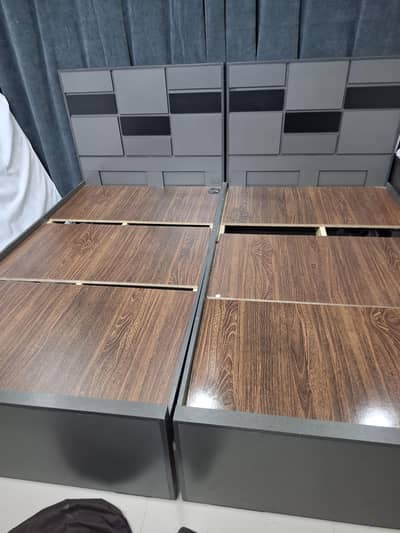 2 single beds with mattress and 1 side table