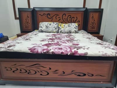bed with side table and dressing table