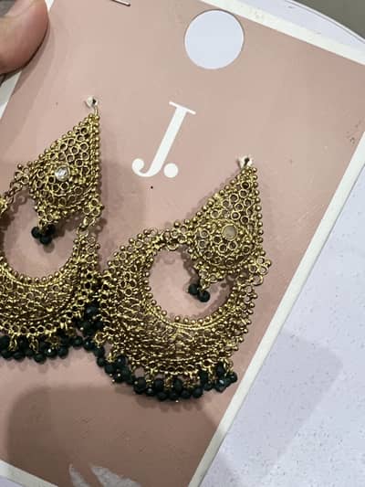 Golden earrings with green beads