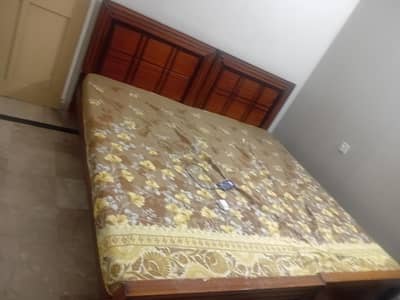 2 single bed made out of wooden without mattress