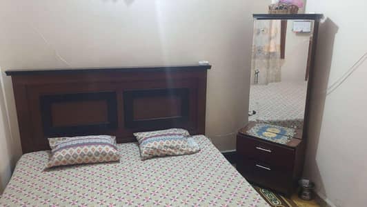 bed, dressing divider and cupboard