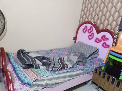 2 single bed without matress with 1 side table and cupboard