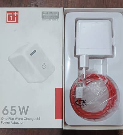 OnePlus charger 65W warp charging along side with OnePlus 8 case.