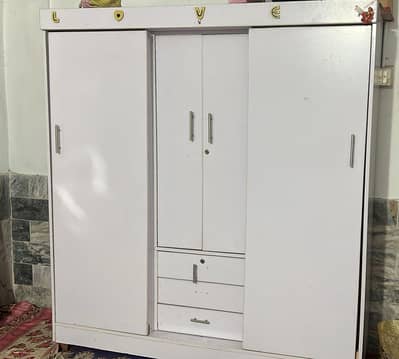 Three-door white wardrobe