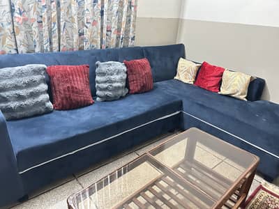 L type sofa with cushions and three tables one mid and two side