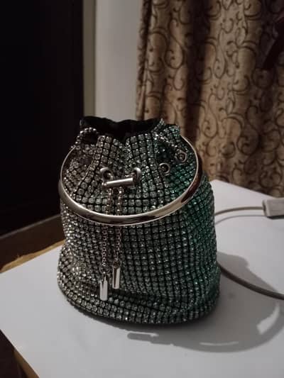 silver and green purse