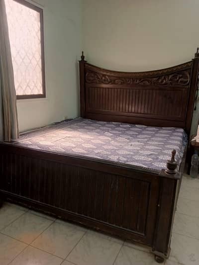 wooden bed and dressing table with two side tables