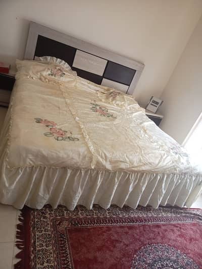 Queen size bed with mattress and bedsheet
