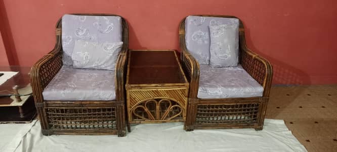 2 sofa seaters with table made of can.